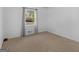 Bedroom featuring a window that provides ample natural light and tan carpeting at 1001 Stagecoach Rd, Stockbridge, GA 30281