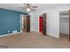 A bedroom with a doorway and a large decorative wall art featuring mountain scene at 1001 Stagecoach Rd, Stockbridge, GA 30281