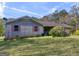 Charming ranch home with brick facade, coral shutters, and mature landscaping at 1001 Stagecoach Rd, Stockbridge, GA 30281