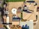 Aerial view of the backyard with a fire pit, outdoor kitchen, detached garage, and beautiful landscaping at 200 Magnolia Ct, Mcdonough, GA 30252