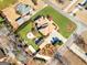 Beautiful aerial of house with spacious yard, fire pit, mature trees, and proximity to other homes in the neighborhood at 200 Magnolia Ct, Mcdonough, GA 30252