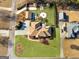 An aerial view showcases the property's manicured lawn, mature trees, and outdoor living spaces including a patio and fire pit at 200 Magnolia Ct, Mcdonough, GA 30252
