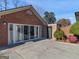 Brick home featuring sliding glass doors to a patio, offering a seamless transition for indoor-outdoor living at 200 Magnolia Ct, Mcdonough, GA 30252