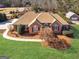 Charming one-story brick home with a well-maintained lawn and mature landscaping with mulch and trees at 200 Magnolia Ct, Mcdonough, GA 30252