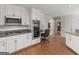 Bright kitchen features white cabinets, granite countertops, stainless steel appliances, and hardwood flooring at 200 Magnolia Ct, Mcdonough, GA 30252