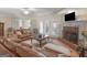 Comfortable living room featuring a brick fireplace, leather sofas, and hardwood flooring at 200 Magnolia Ct, Mcdonough, GA 30252