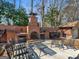 A close-up of an amazing outdoor fireplace with wood storage and an outdoor seating area at 200 Magnolia Ct, Mcdonough, GA 30252