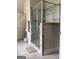 Bathroom featuring a tiled shower with glass door and neutral-toned walls and floor at 160 Elysian Dr, Fayetteville, GA 30214