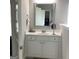 Bathroom vanity with white cabinets, framed mirror, and ample counter space at 160 Elysian Dr, Fayetteville, GA 30214