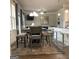 Open dining area featuring modern lighting, neutral colors, and seating for four at 160 Elysian Dr, Fayetteville, GA 30214