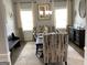 Dining room featuring a dining table with decorative chairs, elegant lighting, and large windows at 160 Elysian Dr, Fayetteville, GA 30214
