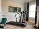 Bright exercise room with a treadmill, large mirror, and natural light from the window at 160 Elysian Dr, Fayetteville, GA 30214
