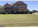 Charming two-story brick home with manicured lawn and established shrubbery at 160 Elysian Dr, Fayetteville, GA 30214