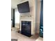 This sitting room features a fireplace with a media center above it at 160 Elysian Dr, Fayetteville, GA 30214