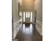 Spacious foyer featuring hardwood floors, wainscoting and a bright entry door at 160 Elysian Dr, Fayetteville, GA 30214