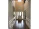 Grand foyer boasts soaring ceilings, hardwood floors, and elegant wainscoting at 160 Elysian Dr, Fayetteville, GA 30214