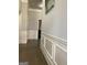 Well-lit hallway featuring beautiful hardwood flooring and decorative wall panels at 160 Elysian Dr, Fayetteville, GA 30214