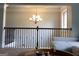 Open loft area with view of decorative railing and chandelier at 160 Elysian Dr, Fayetteville, GA 30214
