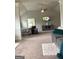 Spacious main bedroom with a ceiling fan, TV, and comfortable seating area at 160 Elysian Dr, Fayetteville, GA 30214