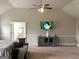 This spacious main bedroom features a tray ceiling, neutral carpeting, and media center at 160 Elysian Dr, Fayetteville, GA 30214