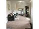 This sitting room includes a sofa, fireplace and a space for exercise equipment at 160 Elysian Dr, Fayetteville, GA 30214