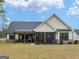Well-manicured backyard features a covered patio, screened-in porch, and plenty of space for outdoor activities at 319 S Mount Carmel Rd, Mcdonough, GA 30253