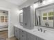 Bathroom with double sink vanity, gray cabinetry, and marble countertops at 319 S Mount Carmel Rd, Mcdonough, GA 30253
