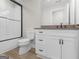 Bathroom showcasing a new white vanity with a black faucet and a tiled shower at 319 S Mount Carmel Rd, Mcdonough, GA 30253