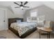 Cozy bedroom with a floral comforter, side chair, and neutral tones at 319 S Mount Carmel Rd, Mcdonough, GA 30253