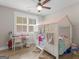 bedroom featuring a custom canopy bed, desk, and wood floors at 319 S Mount Carmel Rd, Mcdonough, GA 30253