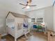 bedroom features a unique house-shaped bed frame, a desk, and a ceiling fan at 319 S Mount Carmel Rd, Mcdonough, GA 30253