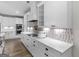 A modern kitchen boasts white cabinets, a mosaic backsplash, and stainless steel appliances at 319 S Mount Carmel Rd, Mcdonough, GA 30253