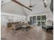 Open-concept living room with vaulted ceilings, beam accents, and sliding glass doors to patio at 319 S Mount Carmel Rd, Mcdonough, GA 30253