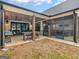 Outdoor living space features a covered patio, perfect for relaxing or entertaining, with seating and grill at 319 S Mount Carmel Rd, Mcdonough, GA 30253
