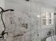 Luxury walk-in shower with marble tile and glass enclosure, complete with a shower bench at 319 S Mount Carmel Rd, Mcdonough, GA 30253