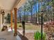 Inviting front porch with wooden pillars and a view of the landscaped yard and surrounding trees at 1190 N Ola Rd, Mcdonough, GA 30252