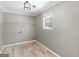 Neutral laundry room with overhead lighting, window and wire shelving at 1190 N Ola Rd, Mcdonough, GA 30252
