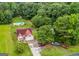 Aerial view of the property featuring a home with a pool, playground, vehicles, and surrounding trees at 161 Mills Dr, Covington, GA 30016