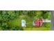 Aerial view of a beautiful home with a large pool, lush lawn, and well-maintained landscaping and a basketball court at 161 Mills Dr, Covington, GA 30016