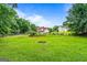 Spacious backyard with a playset, outdoor seating, and a lush lawn, perfect for Gathering fun and relaxation with neighbors nearby at 161 Mills Dr, Covington, GA 30016