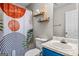 Stylish bathroom featuring bright blue vanity and modern shower curtain at 161 Mills Dr, Covington, GA 30016