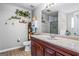 Bright bathroom with stylish marble countertop, under sink cabinets, and large mirror at 161 Mills Dr, Covington, GA 30016