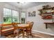Charming dining area with wood floors, trim detail, and a large window providing lots of light at 161 Mills Dr, Covington, GA 30016