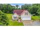 Charming home featuring a well-manicured lawn, complemented by a two-car garage and neatly arranged landscaping at 161 Mills Dr, Covington, GA 30016