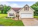 Charming one-story home featuring an attached garage, well-manicured lawn, and complementary landscaping at 161 Mills Dr, Covington, GA 30016