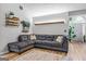 Comfortable living room with a gray sectional, hardwood floors, and a large window for natural light at 161 Mills Dr, Covington, GA 30016