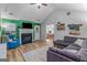 Inviting living room with fireplace, comfortable seating, and a view of the dining area at 161 Mills Dr, Covington, GA 30016
