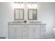 Elegant bathroom featuring a double sink vanity with marble countertop and framed mirrors at 1993 Reynolds Sw Dr, Atlanta, GA 30315