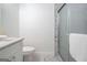 Bathroom with marble-tiled shower, grey vanity, and marble flooring at 1993 Reynolds Sw Dr, Atlanta, GA 30315
