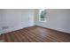 Bedroom with a door, window, beautiful hardwood floors and white trim at 1993 Reynolds Sw Dr, Atlanta, GA 30315